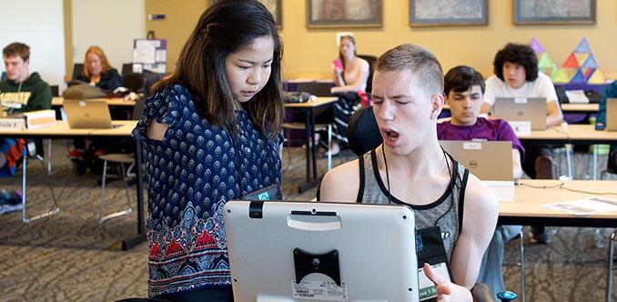 Two students with disabilities work together on the computer. Two students with disabilities work together on the computer.