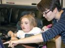 An instructor shows a student how to use a tool on the computer.