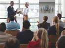 A person accepts an award in front of a crowd.