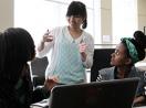 Three deaf students of color work on a computing project together.