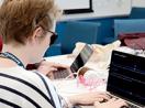 A student with a visual disability codes on a computer during last year's OurCS workshop.