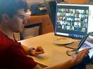 A student uses his Augmentative and Alternative Communication device to access a Zoom class.