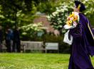 A PhD graduate walks to their ceremony.