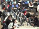 
Still image from video: Students working in a large open computer lab