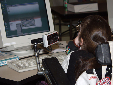 A mobility impaired student working on a computer