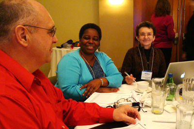 Photo of three faculty members collaborating at a capacity-building institute