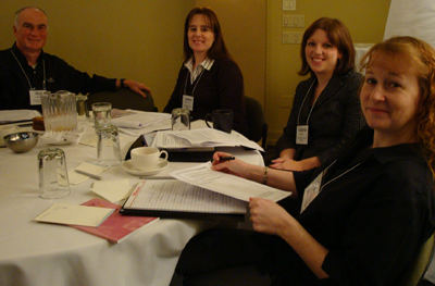 Four CBI participants sit around a table