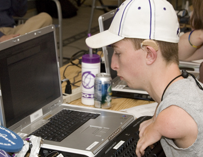 Photo of a student operates his computer using an alternative keyboard