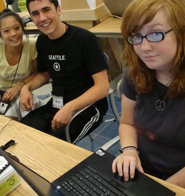 Three students smiling and hanging out