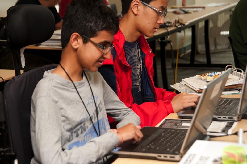 Scholar works on a computer project.