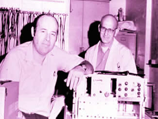 Don Baker (left) and Vern Simmons, a colleague of Baker's in the UW bioengineering lab, display an early pulsed Doppler unit, built in 1967. Simmons built the unit based on a design by Baker.  Photo courtesy Don Baker.
