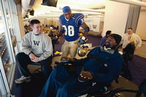 Curtis Willams, right, visited with Jimmy Newell, left, who played with Williams, and freshman safety James Sims Jr., during his trip to campus in April. Photo by Harley Soltes 2002 Seattle Times.