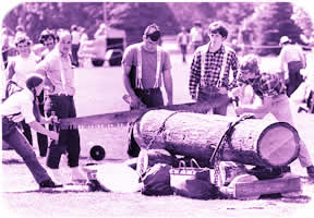 A group of UW students show off their Paul Bunyanesque skills in a log cutting competition on campus in this 1980s-era shot. File Photo.