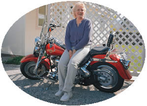 Sheri Mayer rests atop her Harley Davidson motorcycle on the day she moved to Montana, where she and her husband are building a log cabin. Photo by Dathan (Dave) Devnich.