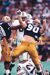 Husky lineman Steve Emtman celebrates a tackle in a 1991 victory over Arizona. Photo by Mark Harrison, copyright 1991 Seattle Times.