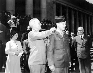 President Harry Truman places the Medal of Honor around the neck of Sgt. John Bud Hawk in a ceremony on the steps of the state capitol. Photo courtesy Truman Presidential Library.