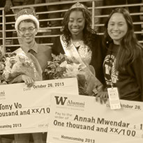 students holding scholarship checks