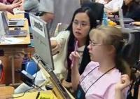 still image from video Equal Access Universal Design in Instruction showing two female DO-IT Scholars using assistive technology at a laptop computer