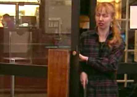 blind student opening a door and using cane still image from video Equal Access Labs showing blind student opening a door and using cane