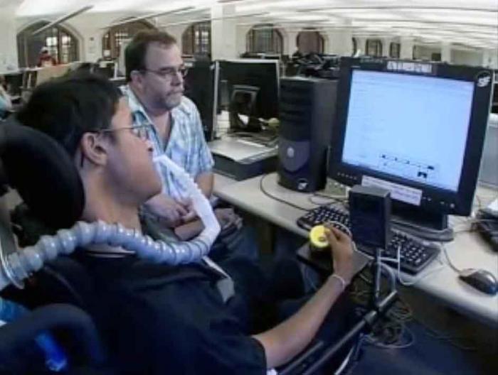 still image from video WT Mobility showing person with disability using assistive technology