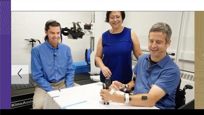 Educators work with a student to test engineering equipment.