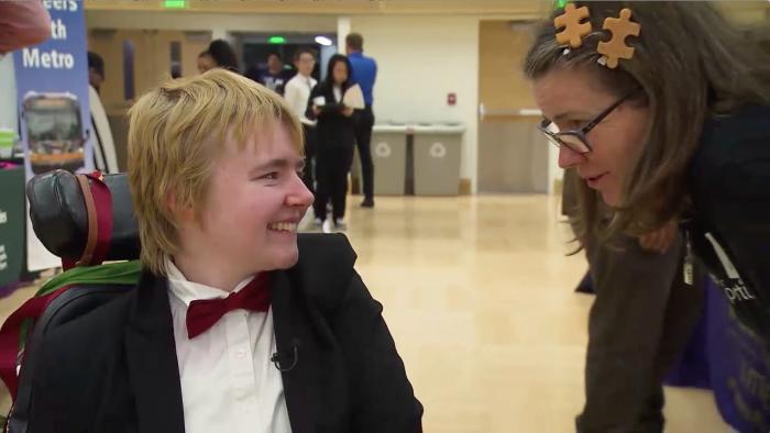 A student in a wheelchair meets a job recruiter.