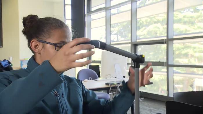 A student moves a tool.