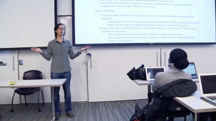Andrew Ko teaches in front of a classroom.