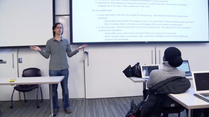 Andrew Ko teaches in front of a classroom.