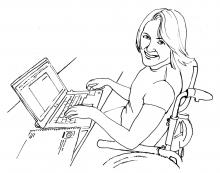 A student smiling while on her computer.
