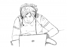 A student wearing a headset while using a laptop.