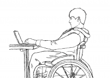 A student in a wheelchair using a laptop.