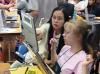 still image from video Equal Access Universal Design in Instruction showing two female DO-IT Scholars using assistive technology at a laptop computer