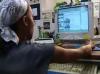 still image from video Learning and Earn Tips showing DO-IT Scholar using assistive technology at computer