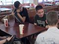 Students sit around a table in the cafeteria.