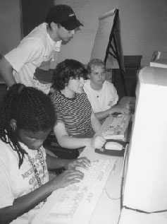 Kris and students using computers at Camp Courage Kris and students at Camp Courage