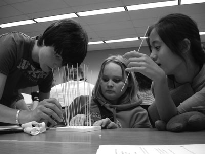 Dylan, Stefani, and Megan at Summer Study 2007 building a water tower made of spaghetti. Picture of Scholars building a water tower made of spaghetti.