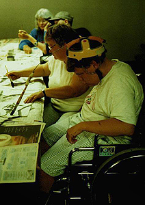 Phase III Scholar Anthony uses his head. Picture of Anthony using his head to paint