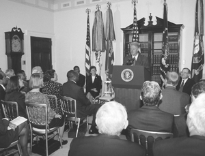 President Clinton awards DO-IT mentor. Picture of President Clinton awarding a DO-IT mentor to a panel.