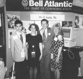 DO-IT staff pose in front of the DO-IT Booth