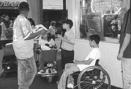 Steven (seated) shares an ice cream snack with DO-IT Scholars and friends. Picture of Steven and DO-IT Scholars.