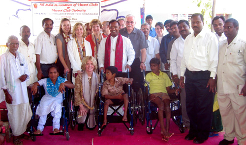 Sheryl Burgstahler, DO-IT director, celebrates with other U.S. and Indian delegates as wheelchairs are donated to people with disabilities. Group photo of conference delegates.