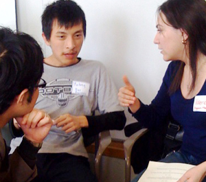 A high school student meets with a mentor from Microsoft and DO-IT Visiting Scholar Takeo for tips on preparing for a career. Picture of 3 people in discussion.