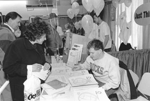 DO-IT Ambassador Eric represents DO-IT at the 1998 UW Computer Fair Picture of Eric answering questions at the DO-IT booth