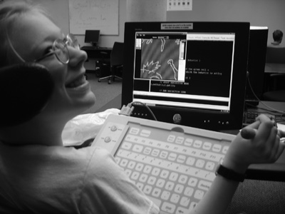 DO-IT Scholar Jenny works on her computer. Picture of Jenny at a computer.
