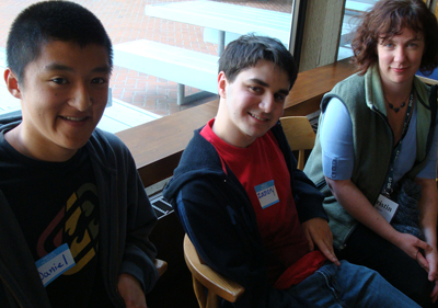 '06 Scholars Daniel and Zachary talk to DO-IT staff Kristin, at the DO-IT Pizza Party. Picture of Daniel, Zacharay and Kristin.