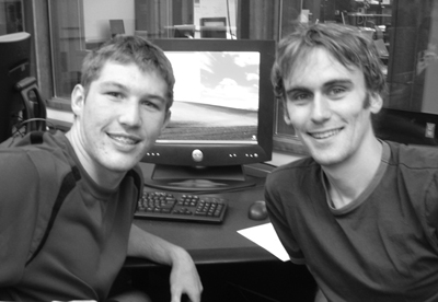 Phase II Scholar Zach works with Game of Life instructor Picture of Zach and and instructor posing at a computer.