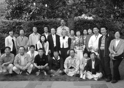 Director Sheryl Burgstahler (center) and husband Dave (behind) entertain visitors from Korea at their home. Group photo of Sheryl Burgstahler and the KISE participants.