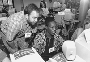 Picture of DO-IT Staff member Dan working with Scholar Raleigh on a computer during Summer Study 2000