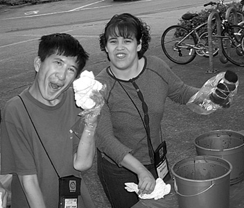 Interns Zachary and Nohemi tie-dying at Summer Study 2002 Picture of DO-IT Interns Zachary and Nohemi tie-dying t-shirts.